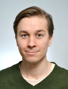 Potrettikuva ruskeahiuksisesta miehestä.