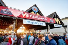 The photo shows the main entrance to VETERAMA at the Maimarkt grounds in Mannheim-Europe's largest classic car market. A long line of people has formed in front of the entrance. Visitors eagerly jostle their way toward the entrance, proving the fair's great popularity and appeal. It's a typical start to an exciting day full of automotive treasures.