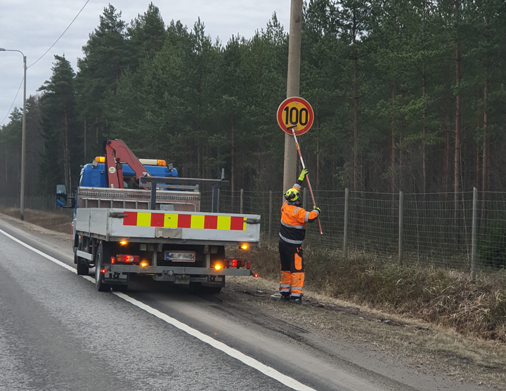 Nopeusrajoitusmerkkiä vaihdetaan tien varressa.