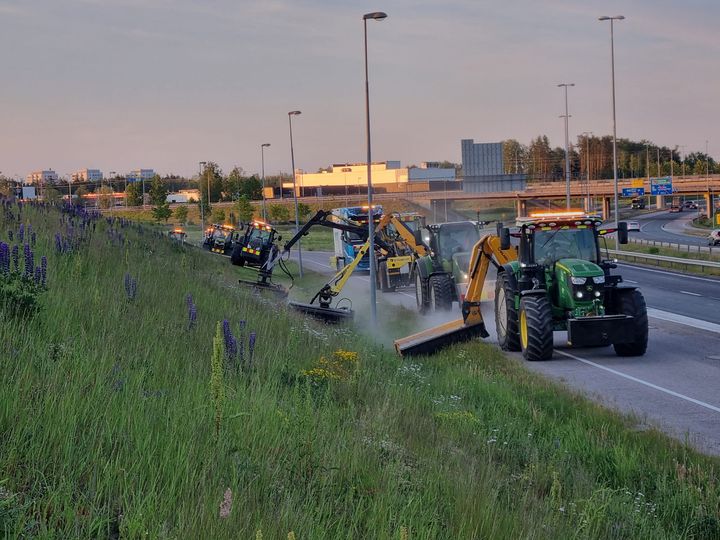 Gräsklippning med traktorer längs en väg vid Ring III.