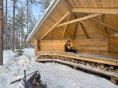 Nainen lukee kirjaa LockCorner laavulla Kokkokalliolla.